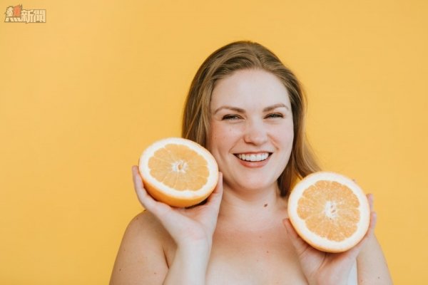 woman holding orange fruits